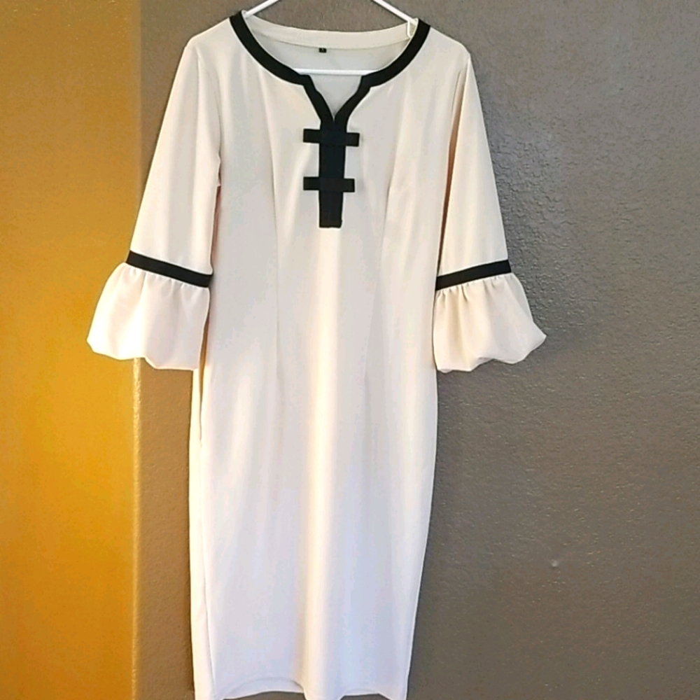 Beautiful cream colored dress with black accents.